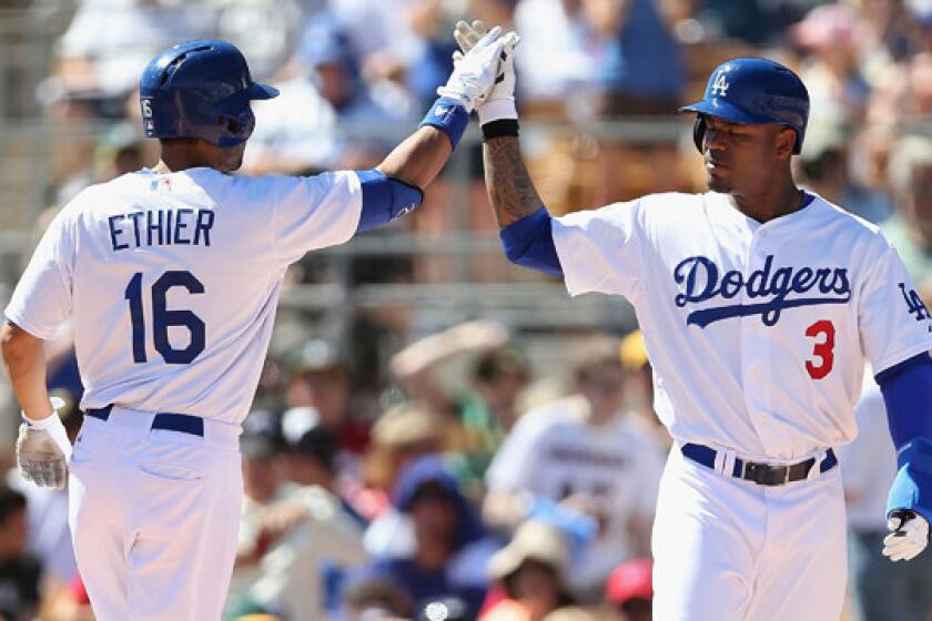 Dodgers outfielder Andre Ethier, left, celebrates with teammate Carl Crawford after hitting a three-run home run against the Oakland Athletics in spring training on March 10. Both players did not start in Saturday's game against the Arizona Diamondbacks.