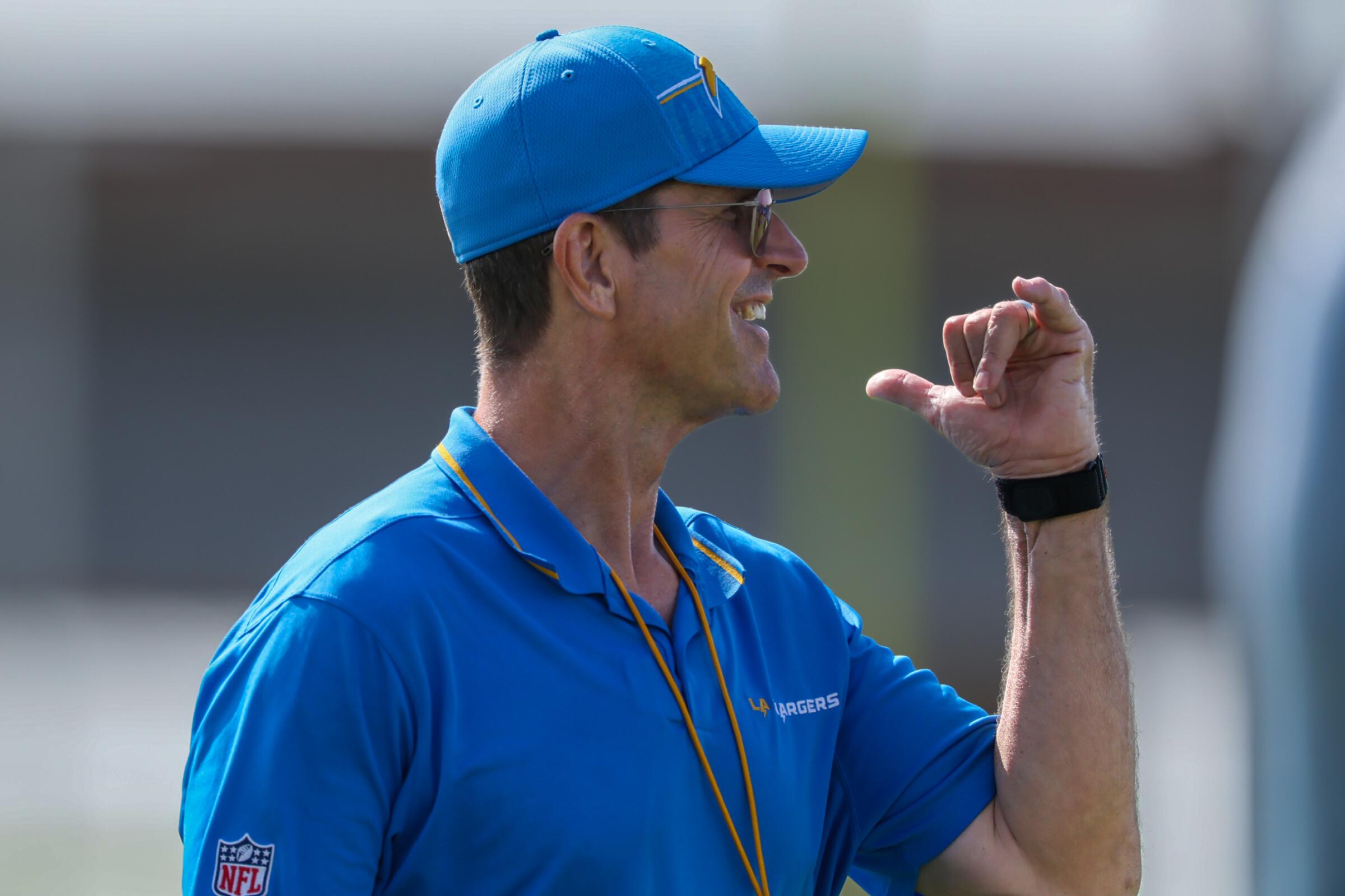 Chargers coach Jim Harbaugh smiles during team training camp in El Segundo.