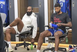 James Harden, left, sits next to Los Angeles Clippers forward Paul George as visits the locker room prior to an NBA basketball game against the Orlando Magic Tuesday, Oct. 31, 2023, in Los Angeles. The Philadelphia 76ers have agreed on a trade to send guard James Harden to the Clippers. (AP Photo/Joe Reedy)