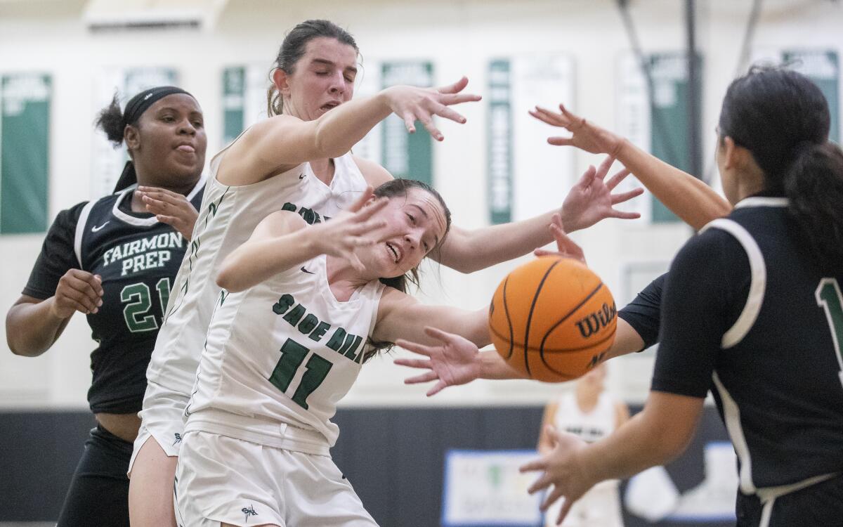 Sage Hill's Emily Eadie, left, and Kat Righeimer attempt to grab a rebound against Fairmont Prep.