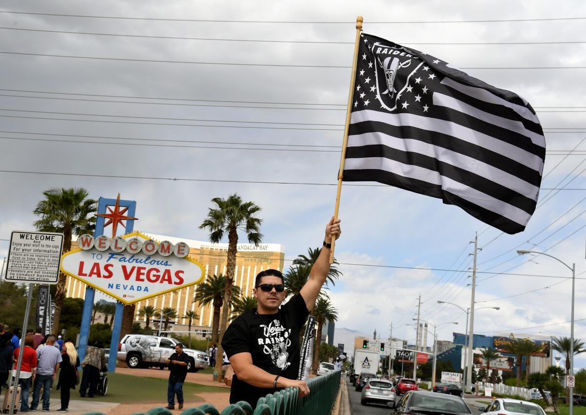 Raiders fan Matt Gutierrez celebrates on March 27, 2017, after NFL owners approved the team's relocation to Las Vegas. The Raiders are set to begin play in their new stadium next season.