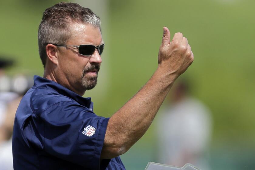 Rams defensive coordinator Gregg Williams stands on the field during training camp.