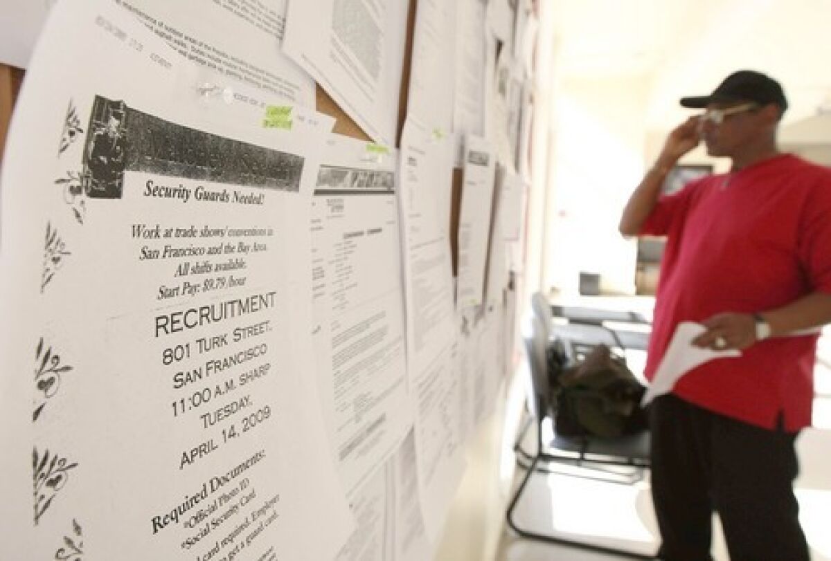 A job seeker browses listings posted at a career center in San Francisco. 