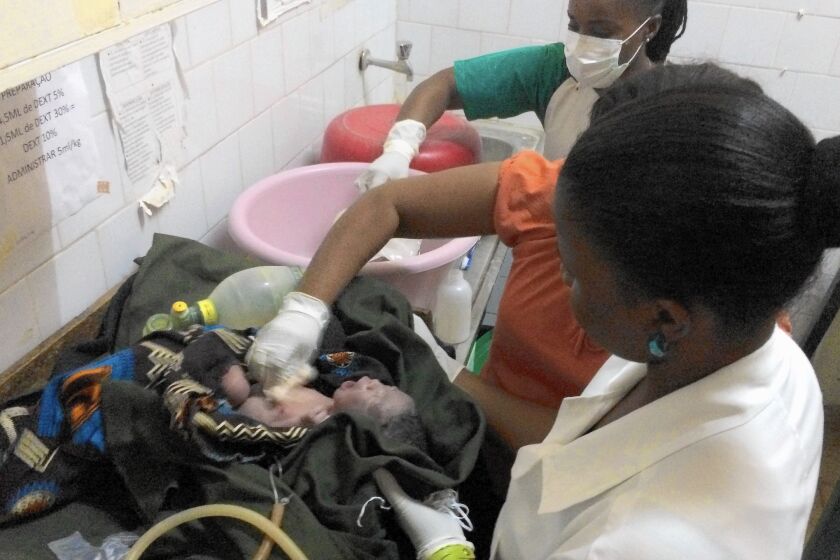 Nurses struggle to save a baby who stopped breathing after he was born at a rural hospital in Chokwe, Mozambique. The child survived.