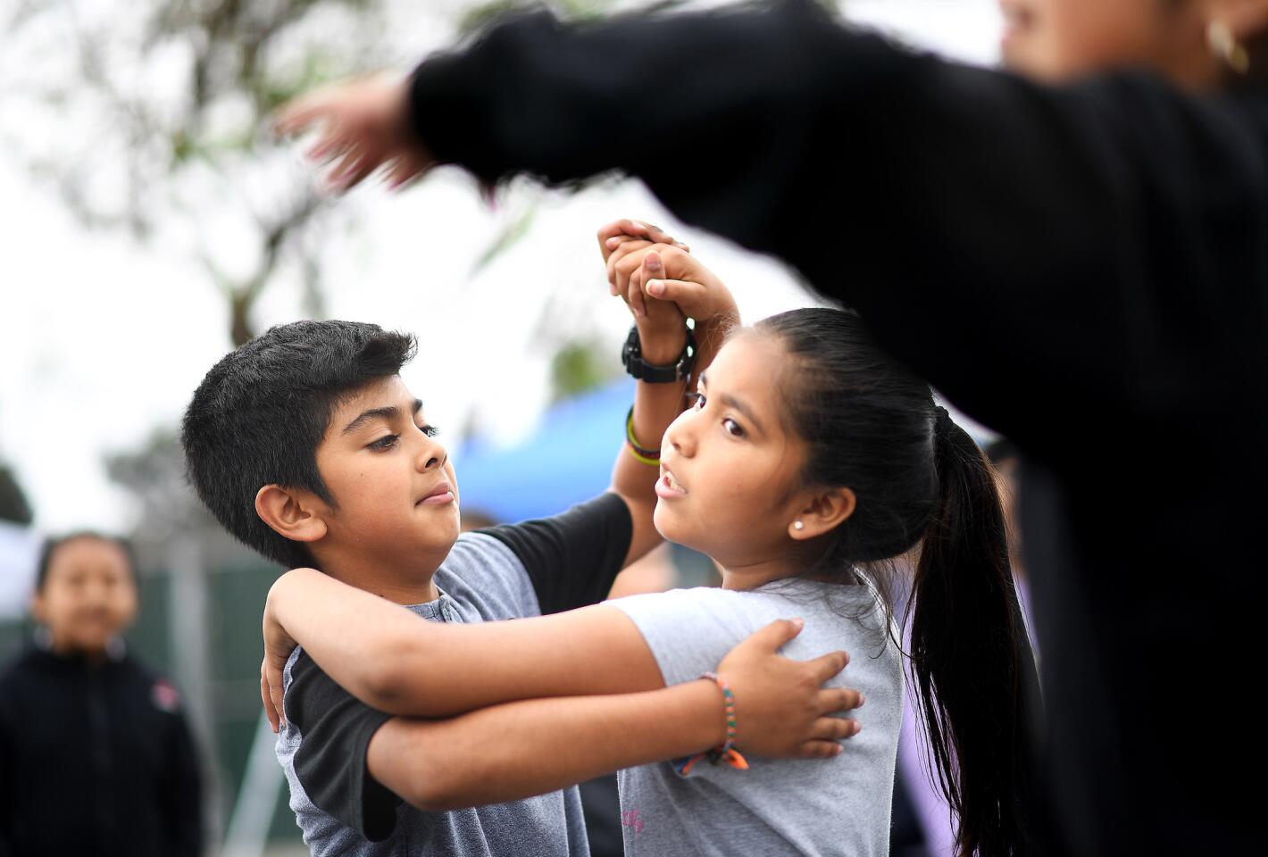 Estrella Elementary School students Eugene Figueroa, left, and Maria Nava practice dancing during their lunch break in Los Angeles on Monday, May 22, 2018.