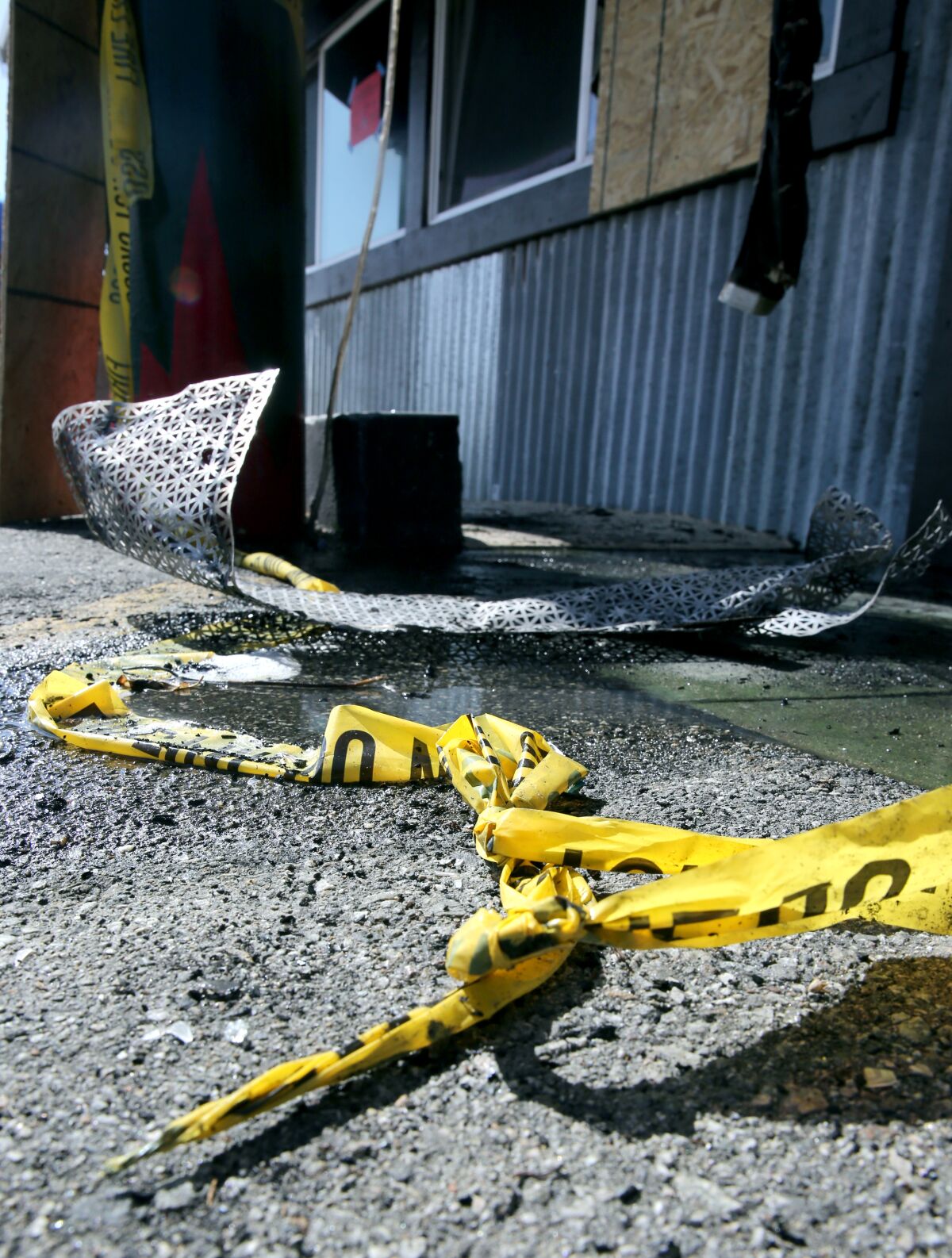 Caution tape and debris leftover Friday from a fire at Taco Surf, in Surfside on Friday.