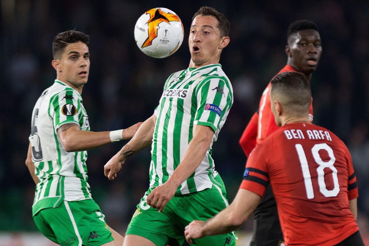 Real Betis' Mexican midfielder Jose Andres Guardado (C) eyes the ball next to Rennes' French forward Hatem Ben Arfa during the UEFA Europa League round of 32 second leg football match between Real Betis and Rennes at the Benito Villamarin stadium in Sevilla on February 21, 2019.