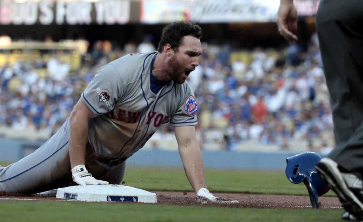 Mets second baseman Daniel Murphy slides into third base with a run-scoring triple against the Dodgers in the first inning of Game 5 of the NLDS.