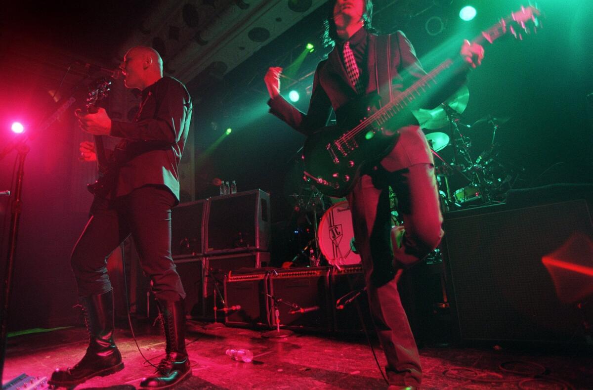 Smashing Pumpkins guitarist James Iha, right, and frontman Billy Corgan perform at Metro in December 1999.