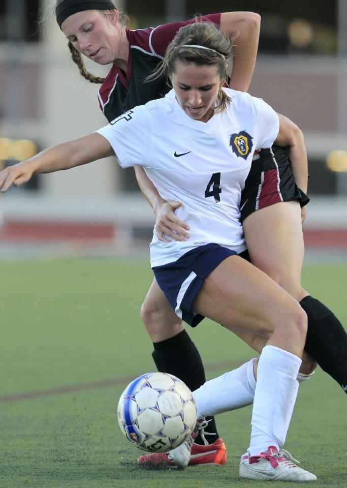 Vanguard's Jordan Davidson (4) keeps the ball away from Westmont's Kaitlynn Durham during the second half at Biola University in La Mirada on Tuesday.