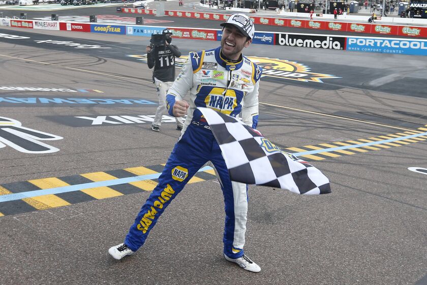 Chase Elliott celebrates at the finish line after winning the season championship and a NASCAR Cup.