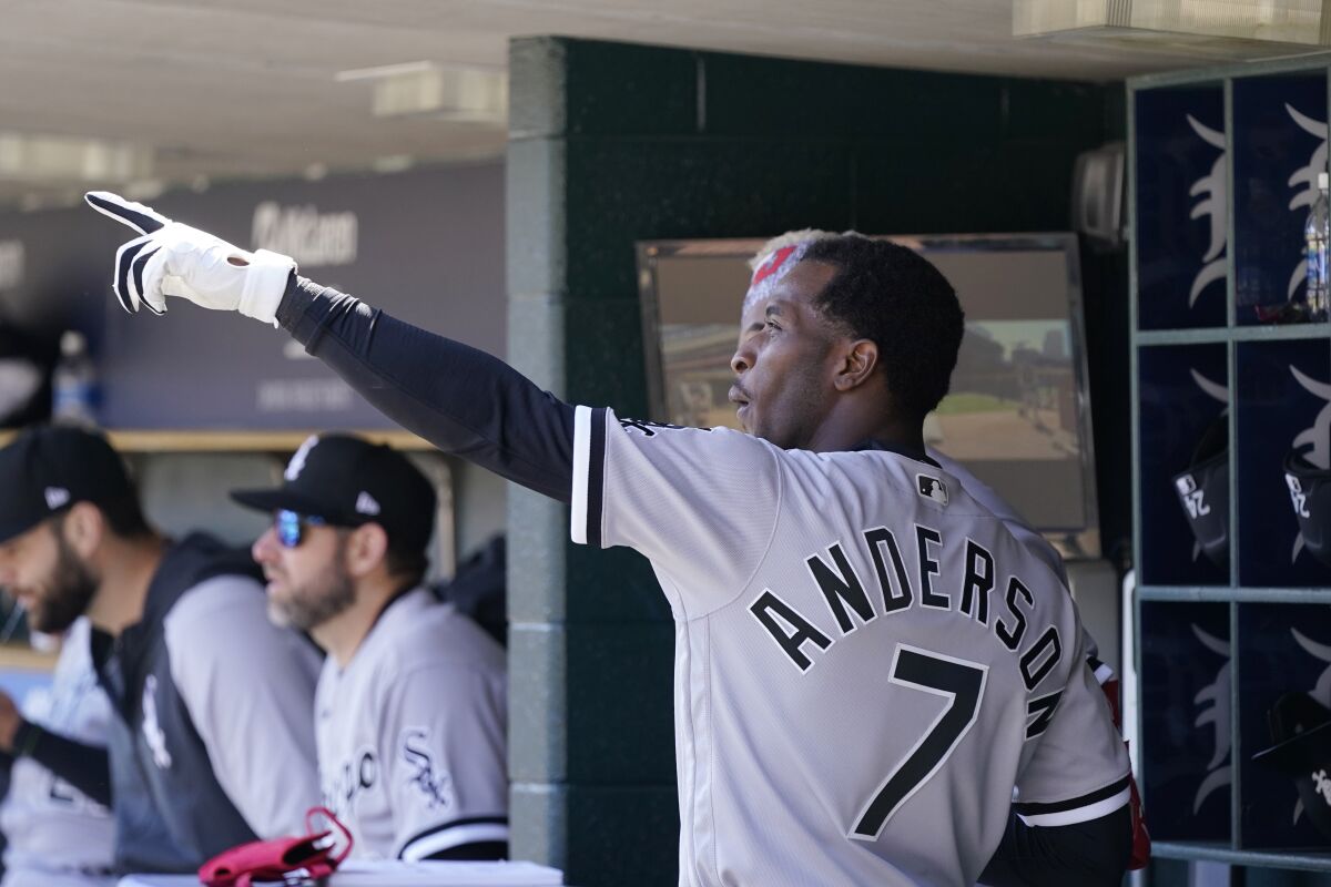 Chicago White Sox shortstop Tim Anderson talks with left fielder Eloy Jimenez in the dugout during the fourth inning of a baseball game against the Detroit Tigers, Sunday, April 10, 2022, in Detroit. (AP Photo/Carlos Osorio)