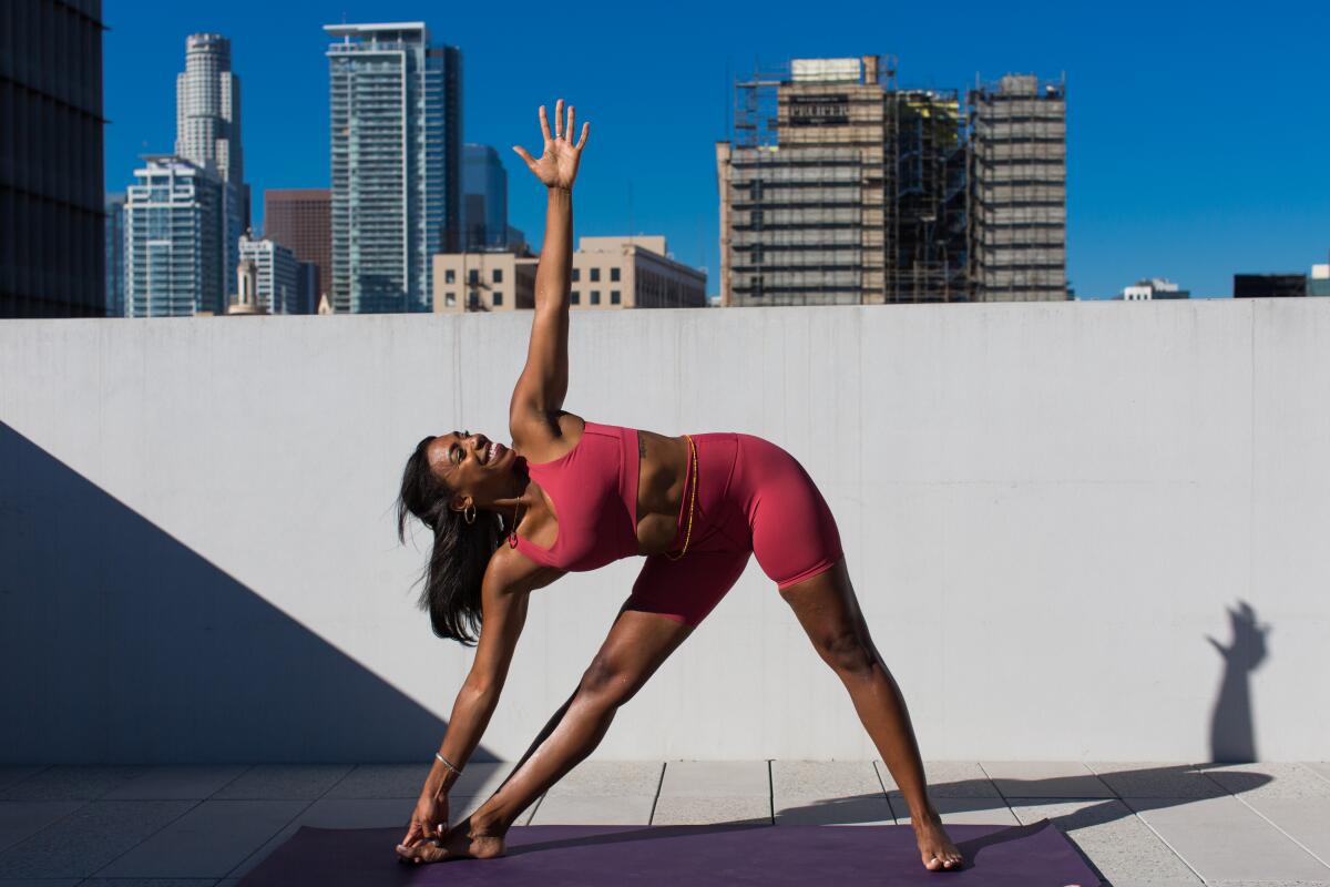 Danielle Richardson does a yoga pose in the sun.