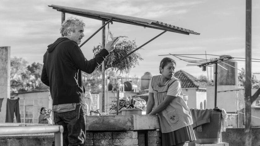 Director Alfonso Cuaron with actress Yalitza Aparicio on the set of "Roma." Netflix reportedly spent at least $25 million on the film's awards campaign.