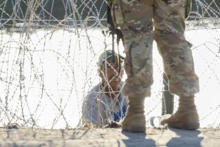 Eagle Pass, Texas, Thursday, September 21, 2023 - A ma pleads with a national guardswoman after burrowing through razor wire in an effort to cross the US/Mexico border along the Rio Grande in Eagle Pass. He was turned away. (Robert Gauthier/Los Angeles Times)