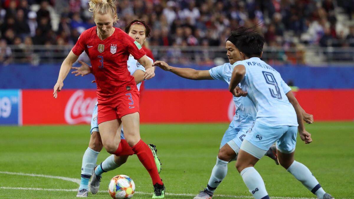 U.S. midfielder Samantha Mewis splits Thailand defenders during their opening Women's World Cup game on Tuesday.