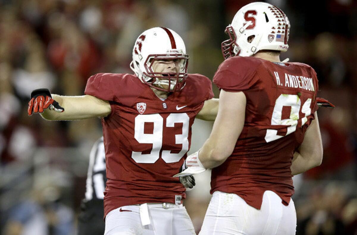 Stanford linebacker Trent Murphy (93) and defensive end Henry Anderson celebrate after sacking Oregon quarterback Marcus Mariota during a game earlier this season.