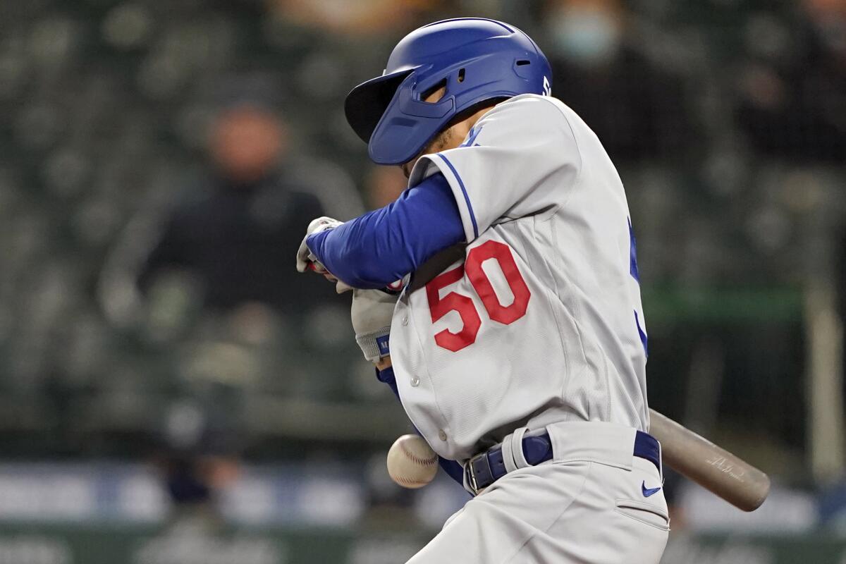 Dodgers right fielder Mookie Betts is hit by a pitch during the ninth inning of a baseball game.