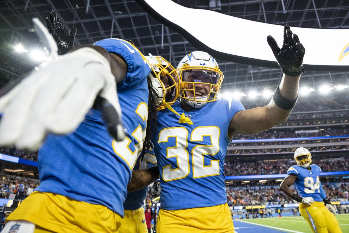Chargers safety Alohi Gilman and cornerback Ja'Sir Taylor celebrate during a win over the Denver Broncos in October.