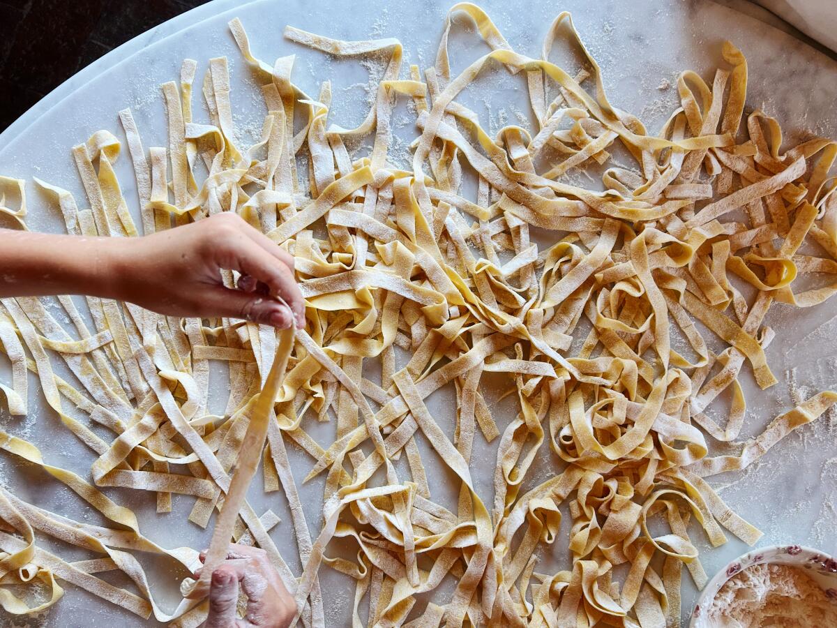 Making fresh tagliatelle, with semolina and type 0 flours and eggs.