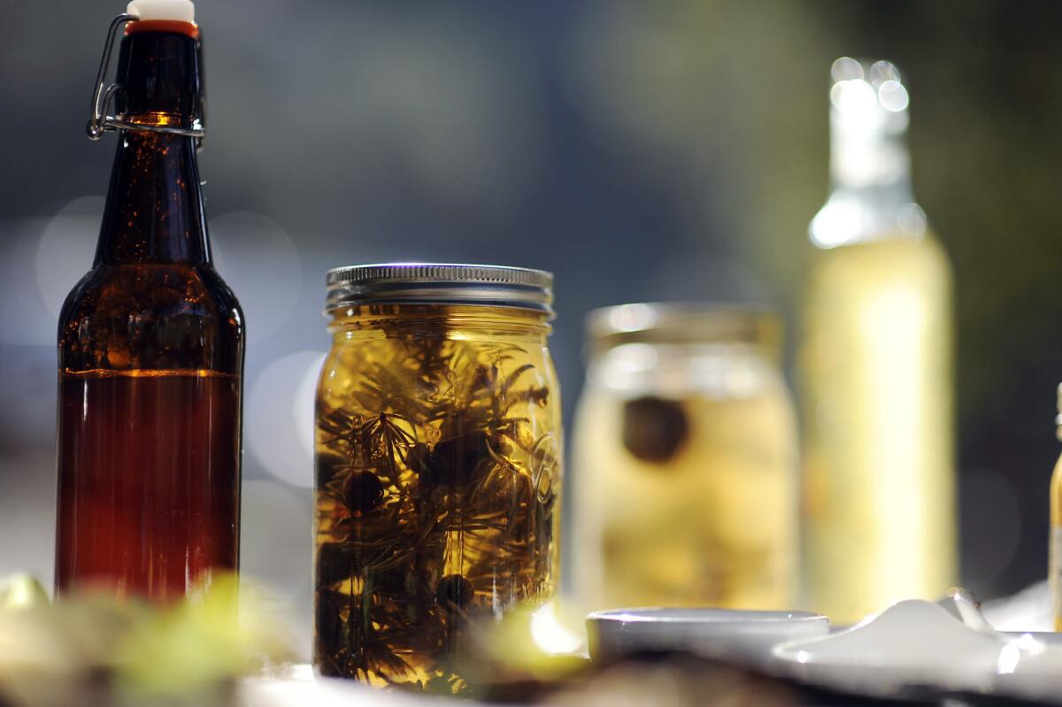A jar of mountain vinegar, which contains manzanita cider vinegar, white fir, juniper berries, pine needles, turkey tail mushrooms and piñon pine needles.