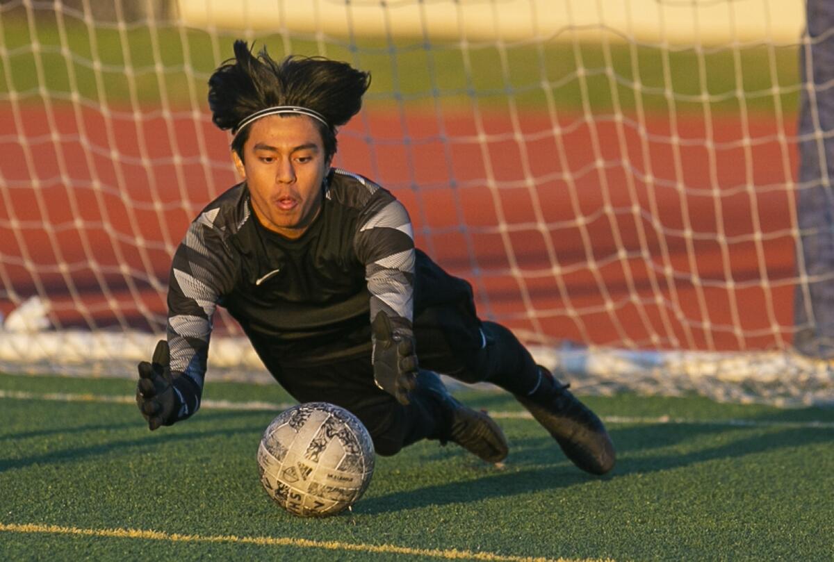 Los Amigos' goalkeeper Jorge Sanchez dives for a shot on goal during a nonleague boys' soccer match on Tuesday.