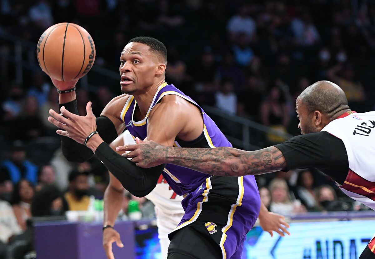 Lakers guard Russell Westbrook is fouled by Heat forward P.J. Tucker while driving to the basket.