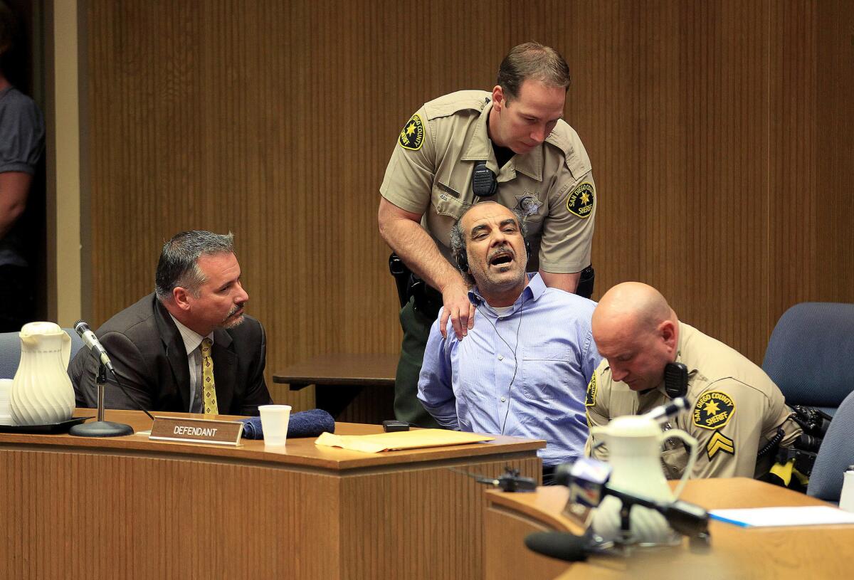 Kassim Al-Himidi, shown reacting to being found guilty in April of killing his wife at their El Cajon home, was sentenced to prison Monday. The Iraqi immigrant sent a note to the judge asking that he be executed and his body returned to Iraq.