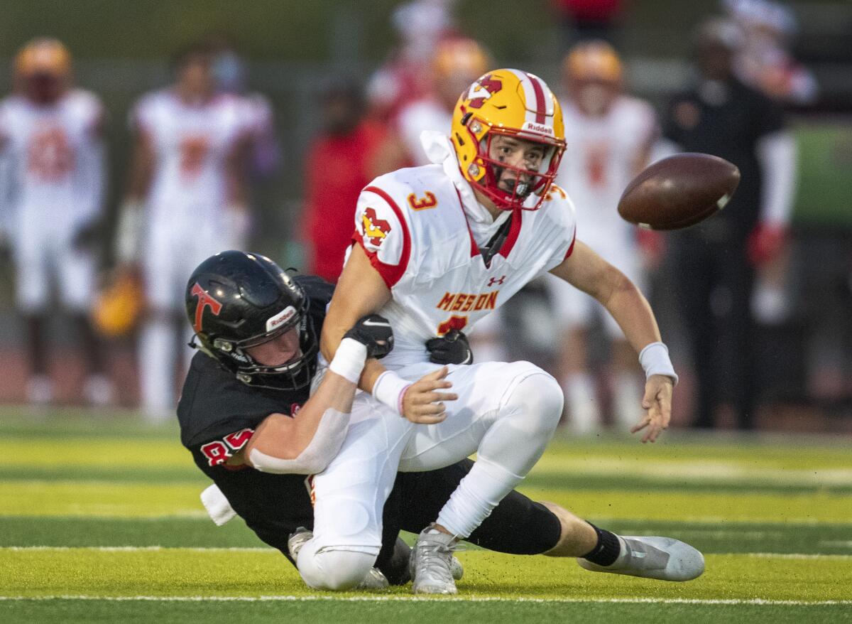 San Clemente outside linebacker Noa Serpa tackles Mission Viejo quarterback Kadin Semonza.