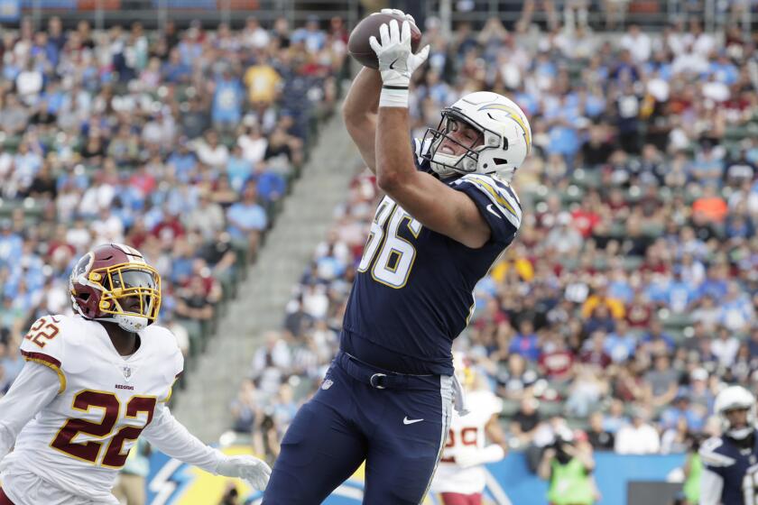 Chargers tight end Hunter Henry hauls in a touchdown pass over Redskins safety Deshazor Everett during the first quarter.