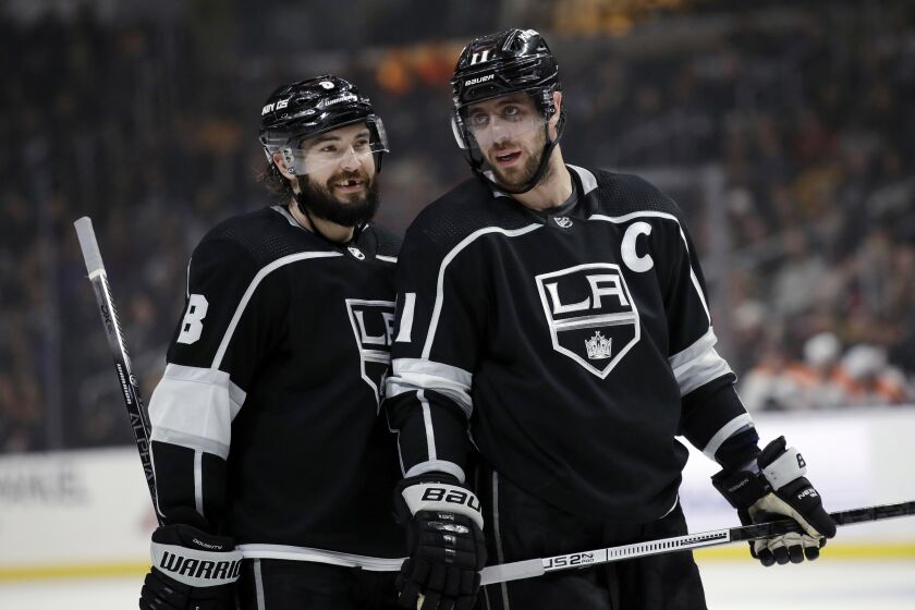 Los Angeles Kings' Anze Kopitar, right, talks to Drew Doughty during the second period of an NHL hockey game against the Philadelphia Flyers Tuesday, Dec. 31, 2019, in Los Angeles. (AP Photo/Marcio Jose Sanchez)