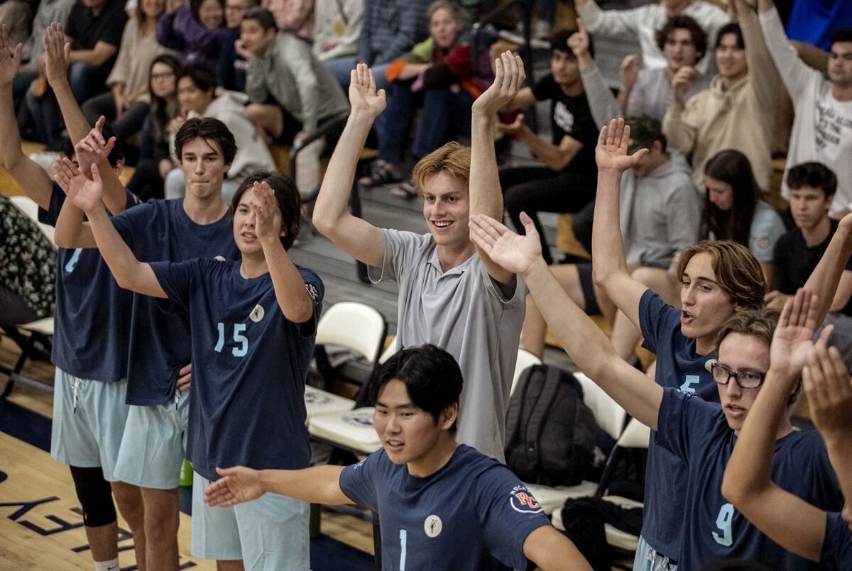 Corona del Mar's George Bruening, center, cheers on the boys' South team on Tuesday.