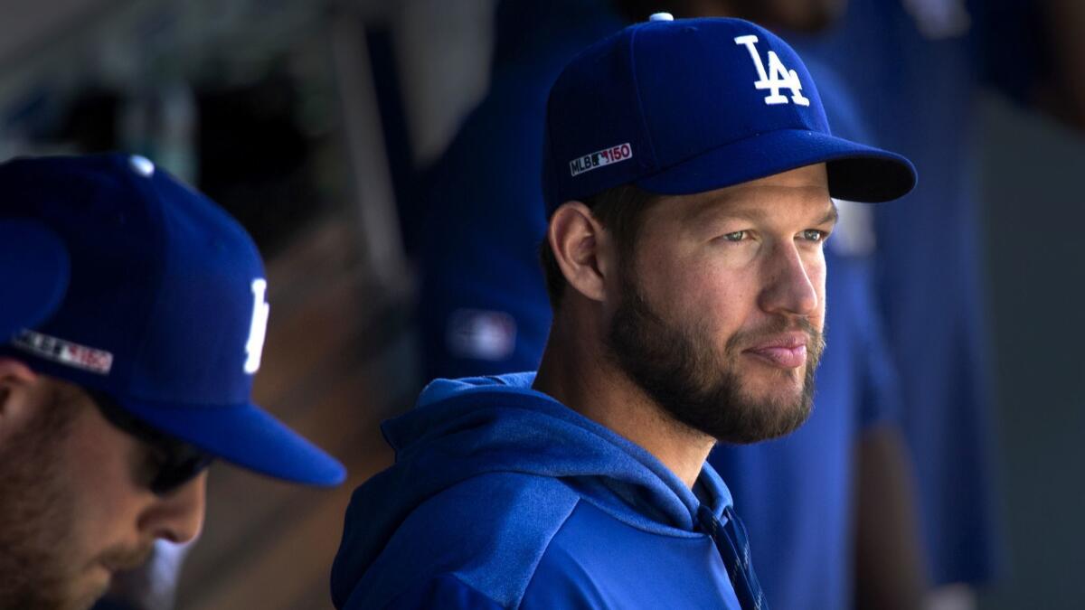 Dodgers pitcher Clayton Kershaw, who is on the 10-day injured list from a left shoulder inflammation, watches the game from the dugout on opening day.