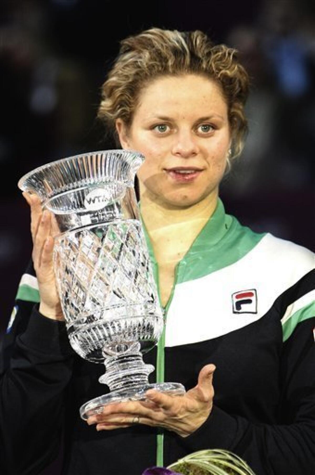 Belgium's Kim Clijsters holds the trophy as she celebrates her win against Australia's Jelena Dokic during the Paris Open tennis tournament at Coubertin stadium in Paris, Friday, Feb. 11, 2011. Clijsters of Belgium secured the No. 1 ranking by defeating Jelena Dokic of Australia 6-3, 6-0 on Friday to reach the semifinals of the Open Gaz de France. (AP Photo/Jacques Brinon)