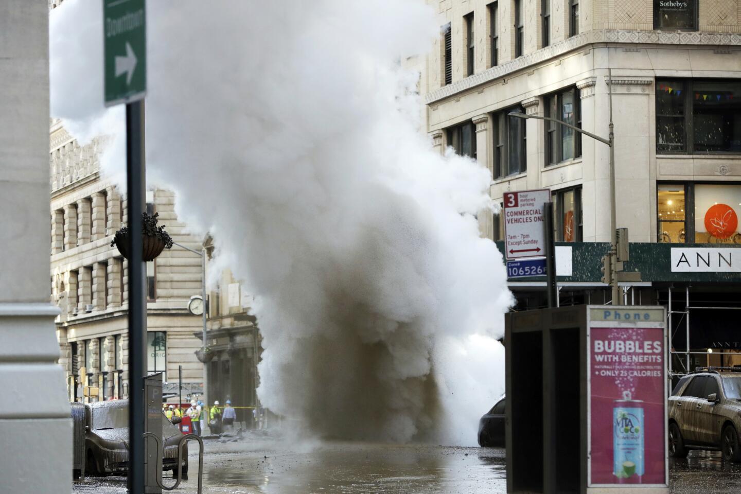 A steam pipe exploded beneath Fifth Avenue in Manhattan early Thursday, sending chunks of asphalt flying, a geyser of billowing white steam stories into the air and forcing pedestrians to take cover.