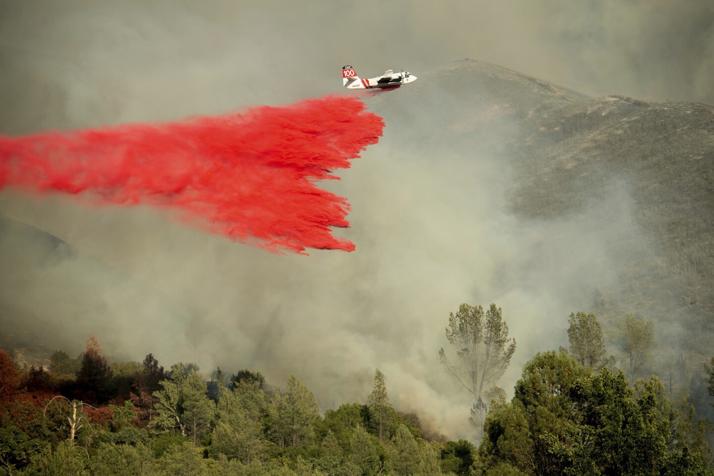 An air tanker drops retardant on a wildfire burning above the Spring Lakes community near Clearlake Oaks, Calif.