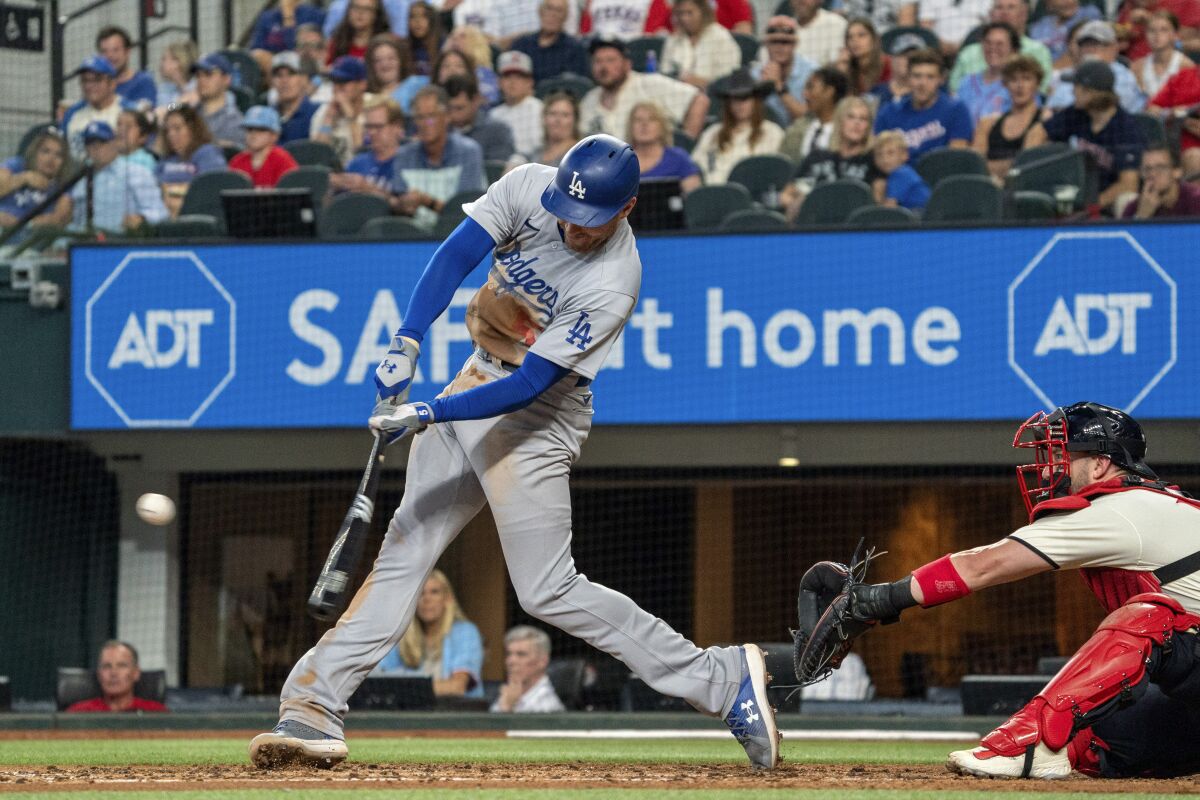 Freddie Freeman connects on a two-run home run in the fourth inning of the Dodgers' 16-3 win over the Texas Rangers.