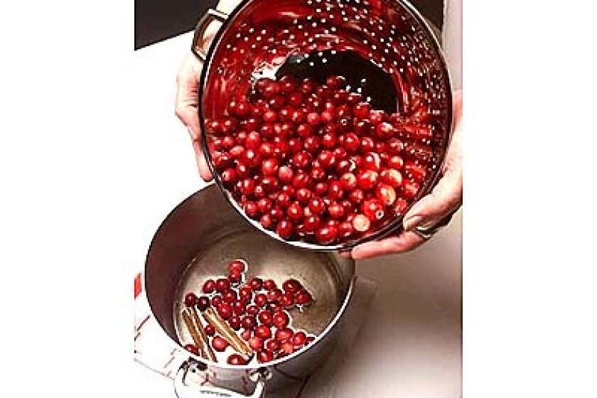 Add cranberries to boiling syrup. Cook cranberries until they begin to pop, then remove from heat.