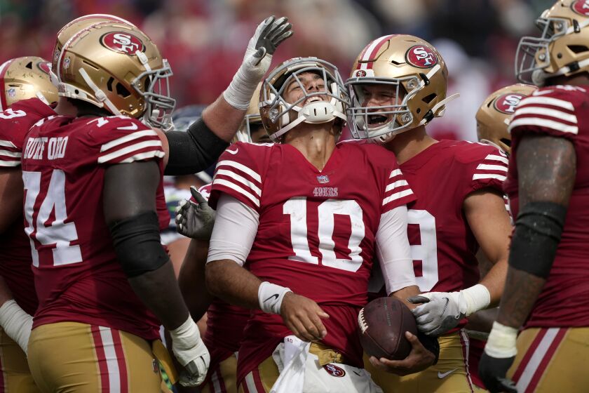 San Francisco 49ers quarterback Jimmy Garoppolo (10) celebrates with teammates during the game against the Seattle Seahawks