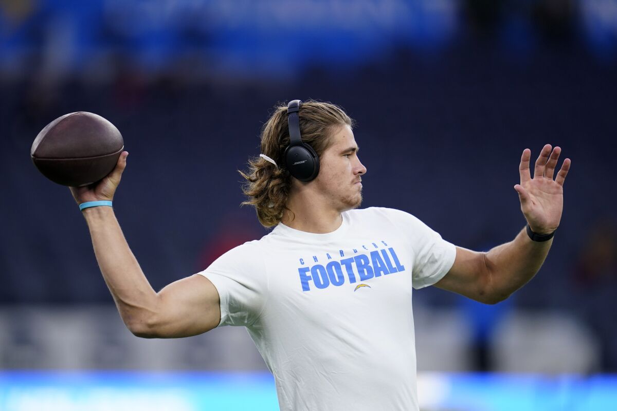Los Angeles Chargers quarterback Justin Herbert warms up before an NFL football game against the Kansas City Chiefs, Thursday, Dec. 16, 2021, in Inglewood, Calif. (AP Photo/Ashley Landis)