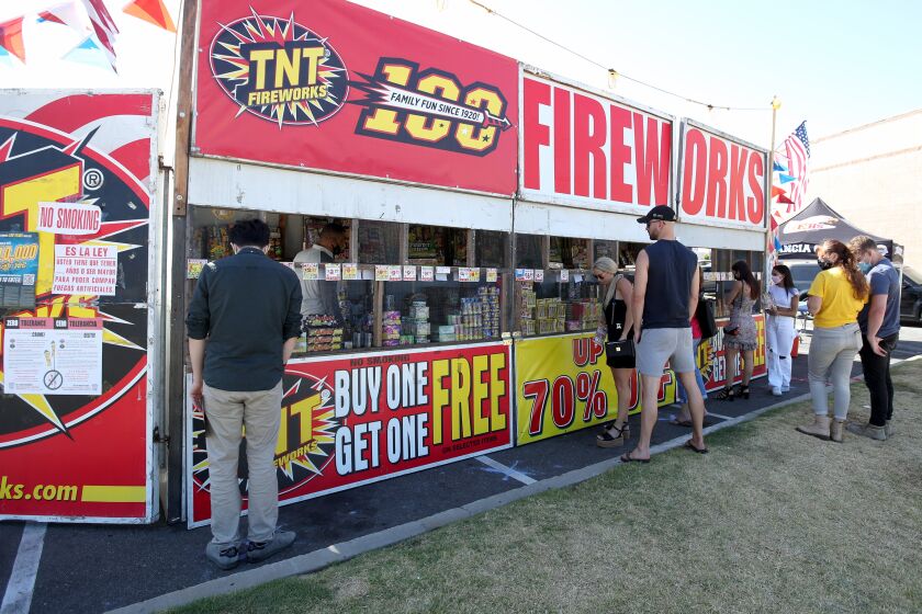 Shoppers looking for fireworks stop by at the TNT Fireworks stand at E. 17th St. and Newport Blvd., in Costa Mesa on Thursday, July 2, 2020. Profits from the stand will benefit the Estancia High School cheerleading and wrestling teams. The stand will be opened Friday 10am to 10 pm and Saturday from 9am until they run out.