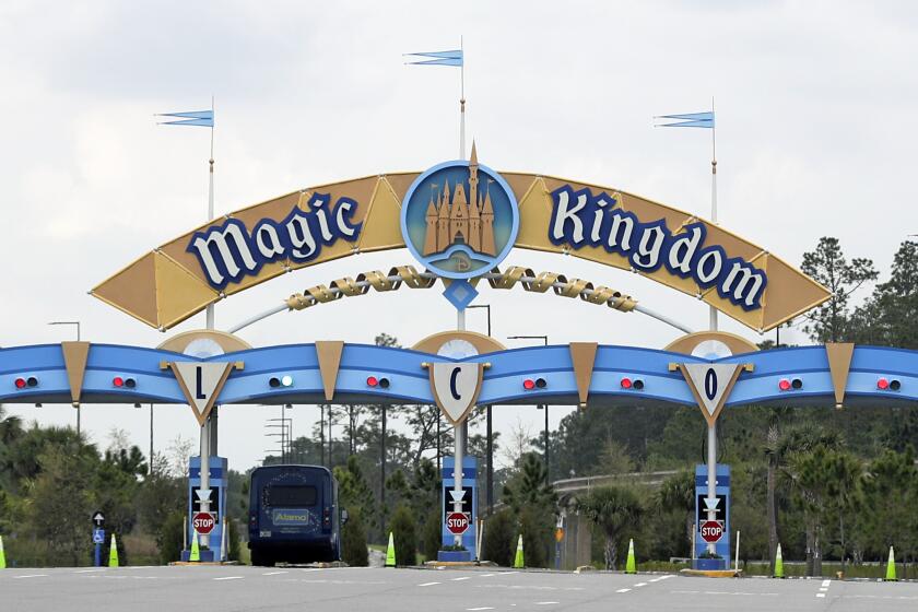 FILE - In this March 16, 2020, file photo, the entrance to the parking lot at the Magic Kingdom at Walt Disney World is closed in Lake Buena Vista, Fla. The House of Mouse is struggling. Its second quarter profit dropped as the company took a $1.4 billion hit due to the coronavirus pandemic. For the January to March quarter, Disney's net income dropped 93 percent to 26 cents per share. Excluding one-time items, net income totaled 60 cents per share. Analysts expected 91 cents per share, according to FactSet. (AP Photo/John Raoux, File)