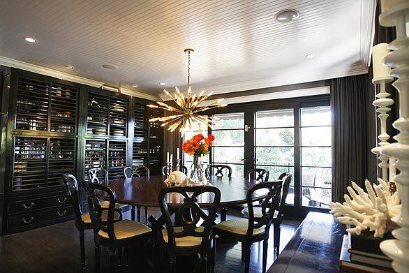 Interior designer Ryan Brown of "Flipping Out" fame and domestic partner, chef Dale Monchamp bought a 1942 two-story stucco house in the Hollywood Hills. In the dining room, Brown covered the ceiling in bead board, which makes the space feel intimate yet casual, he says. The horizontal lines also echo the wall of cabinetry, which Brown created from three matching Chinese pieces, an eye-catching alternative to a built-in unit. He designed the table, which can seat 12. It's built on a base of reclaimed Douglas fir with a distressed walnut top by Ian Ferguson of Dig It Furniture in Venice. "I always tell him to beat up table tops so I don't have to worry about them," Brown says. Though they look like antiques, the dining chairs are a cheat, Brown admits. "I was running out of budget so I got them from Anthropologie and recovered the seats." Full gallery