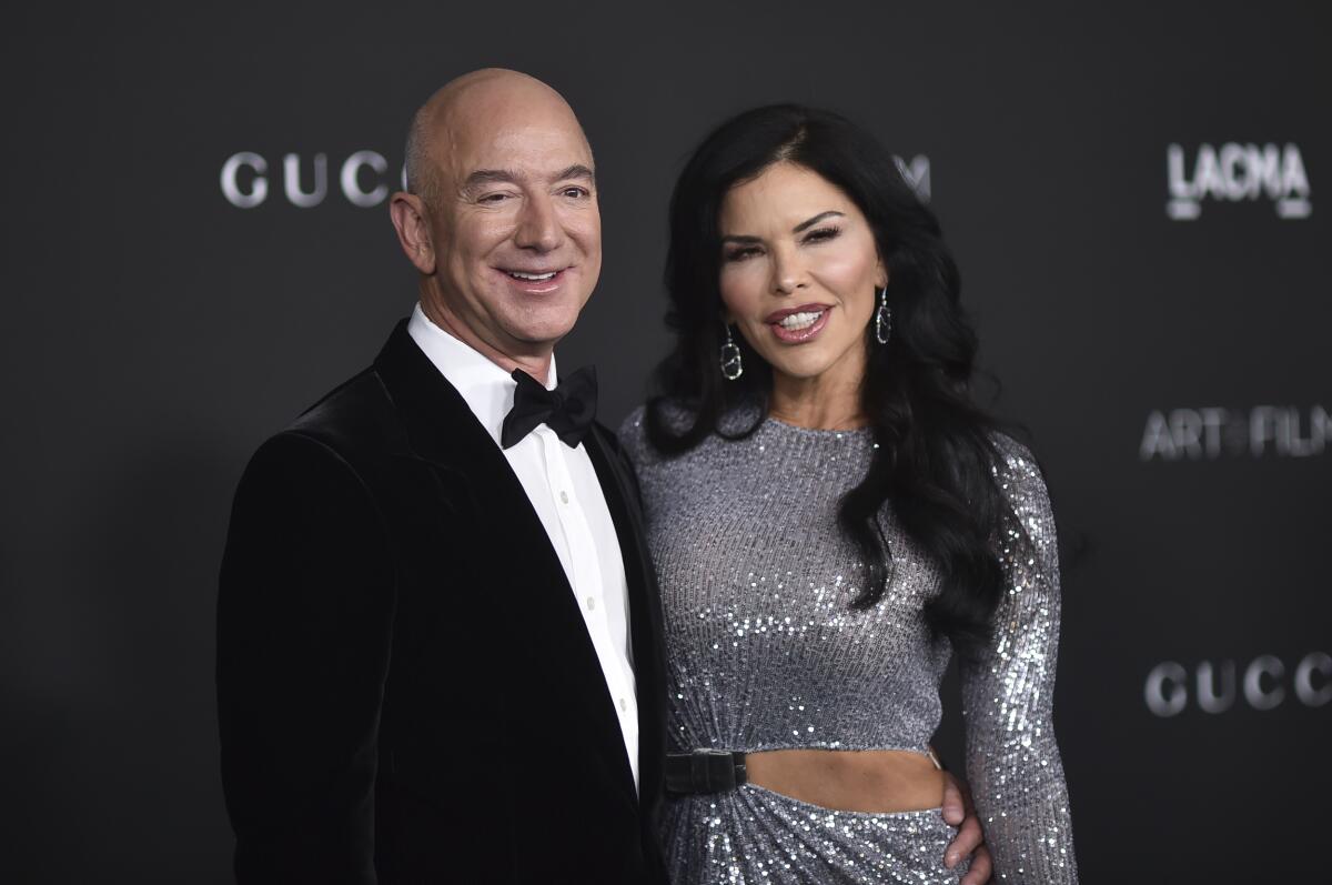 Jeff Bezos and Lauren Sanchez arrive at a formal event.
