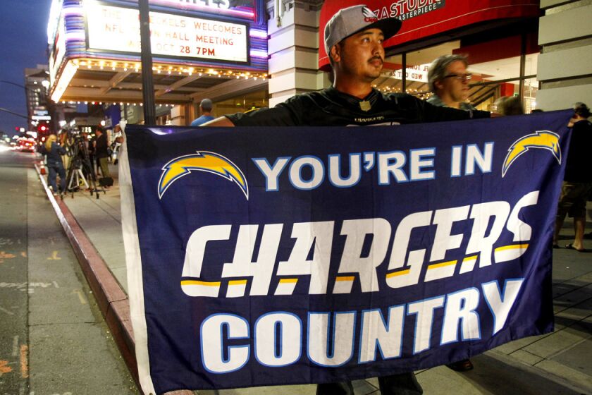 San Diego Chargers fan David Kem holds a Chargers flag before a town hall meeting about the Chargers with NFL representatives on Oct. 28.