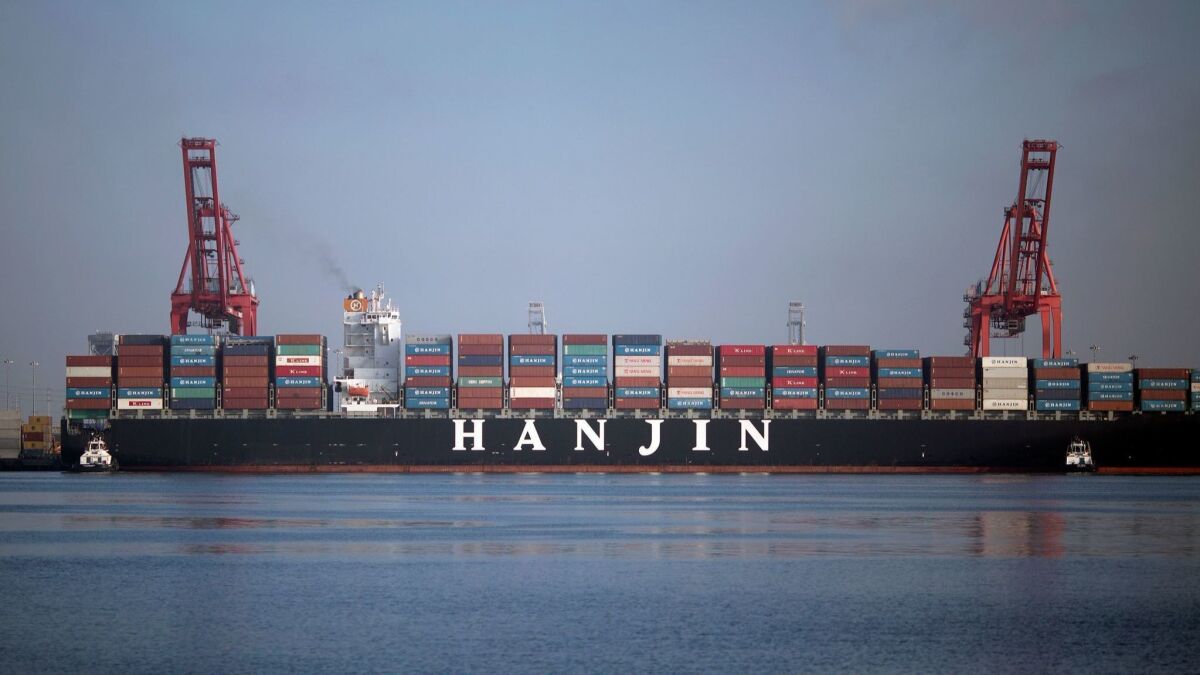 Tug boats push the Hanjin Greece container ship to dock for unloading at the Port of Long Beach, California. U.S. ports are fearful that they will be big losers as the escalating trade fight between Washington and Beijing bites business.