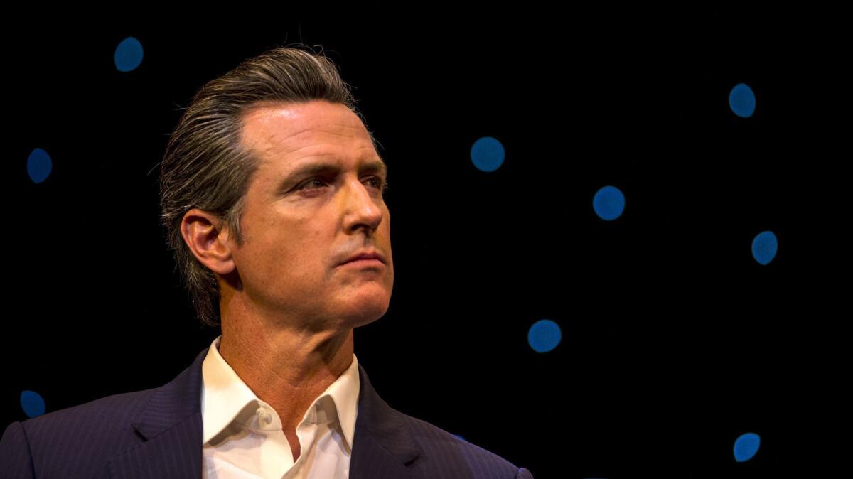 Gavin Newsom looks off to the side