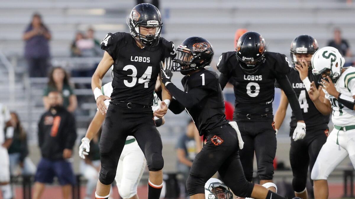 Los Amigos High's Joseph Garcia (34) reacts after tackling Saddleback quarterback Alex Soto in the first half of a nonleague game at Garden Grove High on Thursday.