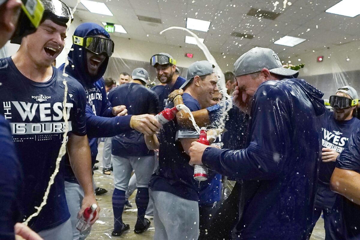 The Dodgers celebrate in the locker room after clinching the National League West title.