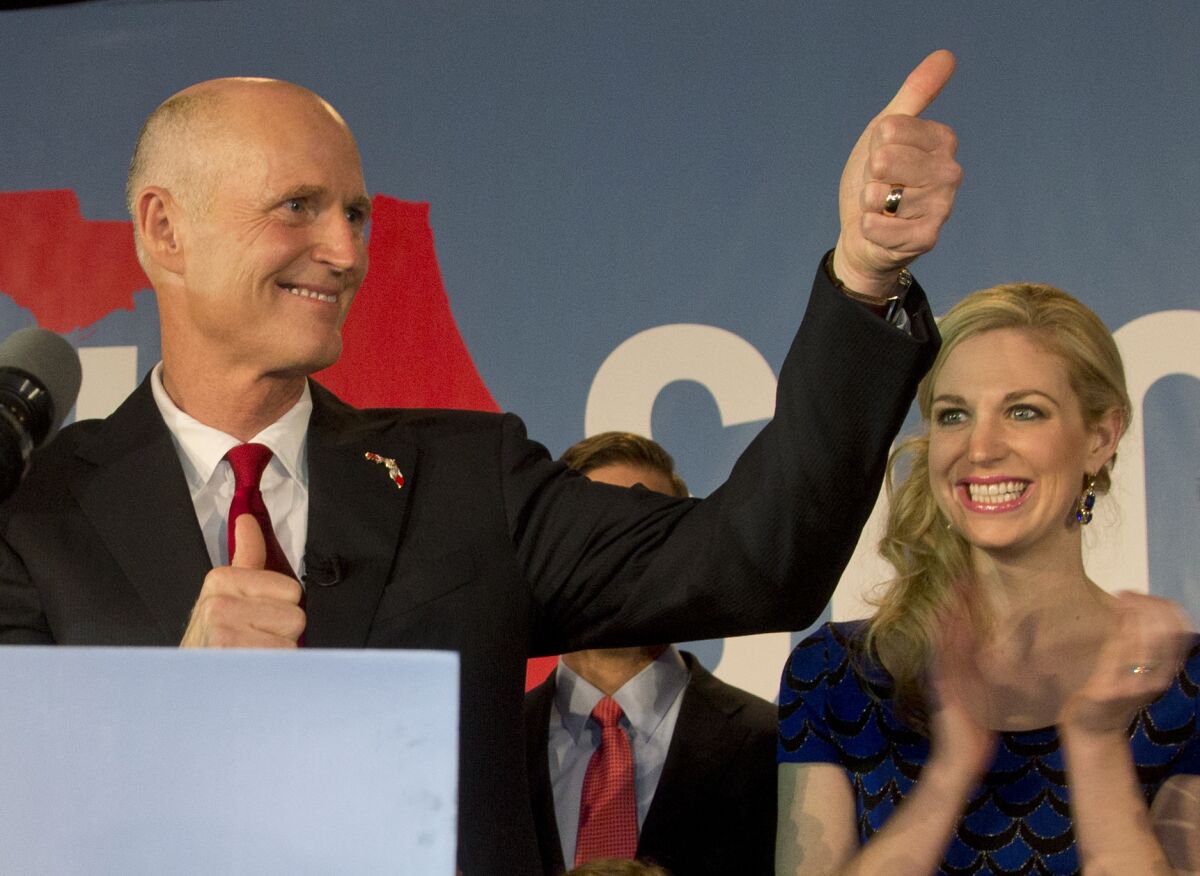 Florida Gov. Rick Scott gives a thumbs up to the crowd after defeating Democratic challenger, former Republican Charlie Crist, in Bonita Springs, Fla.